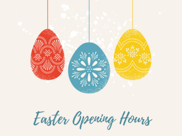 Three Easter eggs dangling on strong on a grey background.